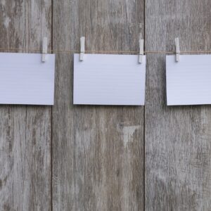 index cards hanging on a string with clothes pins